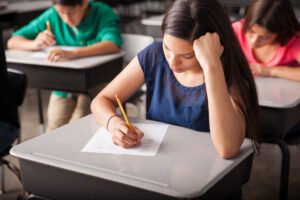 - group high school students taking test classroom